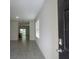 Inviting entryway with neutral tile floors leading to an open floor plan at 17014 Oval Rum Dr, Wimauma, FL 33598