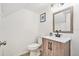 This half-bath features a modern toilet, wood vanity and a square mirror with modern fixtures at 1844 Bough Ave # C, Clearwater, FL 33760