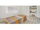 Bedroom featuring wood-look floors, closet, a built-in shelving unit filled with decorative items at 1844 Bough Ave # C, Clearwater, FL 33760