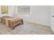 Well-lit bedroom featuring wood-look floors, two windows with blinds, and a colorful bed at 1844 Bough Ave # C, Clearwater, FL 33760