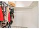 Walk-in closet with clothes on hangers and storage shelves, maximizing storage space at 1844 Bough Ave # C, Clearwater, FL 33760