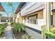 Condo's exterior front walk way and exterior with the lawn in the background at 1844 Bough Ave # C, Clearwater, FL 33760