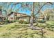 Exterior shot of the condo during the day with a lush lawn and mature trees at 1844 Bough Ave # C, Clearwater, FL 33760