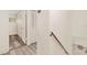 Upstairs hallway featuring wood-look floors, closet doors, and a wooden railing for added style at 1844 Bough Ave # C, Clearwater, FL 33760