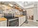 Updated kitchen boasts butcher block counters, brick backsplash, floating shelves, and stainless steel appliances at 1844 Bough Ave # C, Clearwater, FL 33760