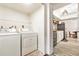 Convenient laundry room next to the kitchen, complete with a washer and dryer at 1844 Bough Ave # C, Clearwater, FL 33760