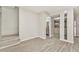 Bright living area with wood-look flooring, neutral walls, and open access to the kitchen and bathroom at 1844 Bough Ave # C, Clearwater, FL 33760