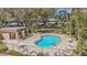 Overhead view of the Kidney-shaped community pool with a surrounding fence and lounge furniture at 1844 Bough Ave # C, Clearwater, FL 33760
