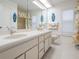 Bright bathroom featuring a double vanity, large mirrors, and colorful decor for a refreshing and functional space at 18806 Autumn Lake Blvd, Hudson, FL 34667