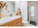 Functional bathroom featuring a single sink with wood cabinets, a mirror, and a toilet for daily use at 18806 Autumn Lake Blvd, Hudson, FL 34667
