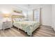 Comfortable bedroom featuring a queen bed with coordinated linens, side tables with lamps, and ample natural light at 18806 Autumn Lake Blvd, Hudson, FL 34667