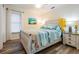 Bedroom featuring a queen bed with coordinated linens, side tables with lamps, and ample natural light at 18806 Autumn Lake Blvd, Hudson, FL 34667