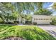 Charming single-story home with a well-manicured lawn, mature trees, and inviting curb appeal at 18806 Autumn Lake Blvd, Hudson, FL 34667