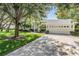 Traditional home exterior with a well-manicured lawn and a multi-car garage at 18806 Autumn Lake Blvd, Hudson, FL 34667