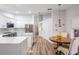 Modern kitchen and dining nook with stainless steel appliances, updated cabinets, and stylish lighting at 18806 Autumn Lake Blvd, Hudson, FL 34667
