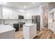 Modern white kitchen with stainless steel appliances, sleek countertops, and ample cabinet space at 18806 Autumn Lake Blvd, Hudson, FL 34667