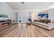 Bright living room with a fireplace, plush seating, and a large painting adding character at 18806 Autumn Lake Blvd, Hudson, FL 34667