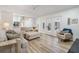 Spacious living room featuring neutral tones, hardwood floors and direct access to the porch via sliding glass doors at 18806 Autumn Lake Blvd, Hudson, FL 34667