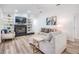 Cozy living room with built-in shelving, a fireplace, and comfortable seating, perfect for relaxation and entertainment at 18806 Autumn Lake Blvd, Hudson, FL 34667
