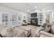 Comfortable living room with a fireplace, built-in shelving, and access to an enclosed pool area at 18806 Autumn Lake Blvd, Hudson, FL 34667