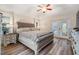 Spacious main bedroom with patio access, wood floors and tray ceiling with fan at 18806 Autumn Lake Blvd, Hudson, FL 34667