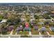 Aerial view of homes in a residential area featuring a highlighted home for sale and community features like mature trees at 20191 Rutherford Ave, Port Charlotte, FL 33952