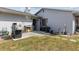 Rear patio featuring a grill, external storage, and access to utilities in a convenient outdoor space at 20191 Rutherford Ave, Port Charlotte, FL 33952