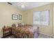 Cozy bedroom with a ceiling fan, natural light, and laminate wood flooring at 20191 Rutherford Ave, Port Charlotte, FL 33952