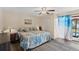 Bedroom featuring beachy decor, with a king size bed, ceiling fan and access to outdoor living at 20191 Rutherford Ave, Port Charlotte, FL 33952