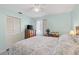 Comfortable bedroom with a ceiling fan, dresser, TV, and light blue walls at 20191 Rutherford Ave, Port Charlotte, FL 33952