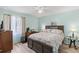 This light and airy bedroom provides a ceiling fan, laminate wood floors and a king size bed at 20191 Rutherford Ave, Port Charlotte, FL 33952
