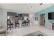 Bright kitchen offers seating at the breakfast bar, ample gray cabinets, and modern stainless appliances at 20191 Rutherford Ave, Port Charlotte, FL 33952