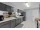 Modern kitchen with stainless steel appliances, gray cabinets, and ample counter space at 20191 Rutherford Ave, Port Charlotte, FL 33952