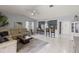 Open-concept living room with tile flooring and seamless flow into the kitchen area at 20191 Rutherford Ave, Port Charlotte, FL 33952