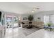 Spacious living room with access to the pool area through sliding glass doors at 20191 Rutherford Ave, Port Charlotte, FL 33952