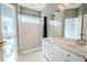 Bathroom featuring a large shower and double sink vanity with ample counter space and storage at 230 Gray Oak Dr, Tarpon Springs, FL 34689