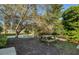 Backyard with a picnic table near a small pond surrounded by lush landscaping at 2982 Estancia Pl, Clearwater, FL 33761