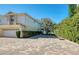 Inviting townhouse featuring a two-car garage and a brick-paved driveway and a basketball hoop at 2982 Estancia Pl, Clearwater, FL 33761