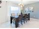 The dining room features stylish lighting and a large window with sheer curtains at 29922 Marquette Ave, Wesley Chapel, FL 33545
