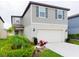 Charming two-story home featuring a two-car garage and beautifully landscaped front yard at 29922 Marquette Ave, Wesley Chapel, FL 33545