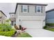 Beautiful two-story home with a two-car garage and lush landscaping at 29922 Marquette Ave, Wesley Chapel, FL 33545