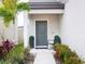 Charming front porch featuring a cozy seating area and lovely landscaping at 29922 Marquette Ave, Wesley Chapel, FL 33545