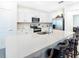 Bright kitchen features an island with seating, stainless appliances, and white cabinets at 29922 Marquette Ave, Wesley Chapel, FL 33545