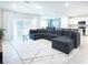 Spacious living room with modern sectional sofa and bright, airy ambiance at 29922 Marquette Ave, Wesley Chapel, FL 33545