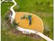 Community playground with a winding sidewalk, green space, and mature trees at 29922 Marquette Ave, Wesley Chapel, FL 33545