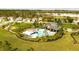 Community pool area showcasing lounge chairs, umbrellas, and a playground at 29922 Marquette Ave, Wesley Chapel, FL 33545
