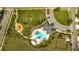 Aerial shot of a resort style pool, playground, and green spaces in a well-maintained community at 29922 Marquette Ave, Wesley Chapel, FL 33545
