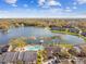 Community with lake, swimming pool, mature trees, grassy areas, parking, and sunny blue skies with clouds at 302 Lake Parsons Grn # 201, Brandon, FL 33511