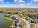 Aerial view of the condo community featuring mature trees, green space, parking, and a pond at 302 Lake Parsons Grn # 201, Brandon, FL 33511