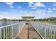 Charming gazebo on a lake with a white fence and a serene view of the water at 302 Lake Parsons Grn # 201, Brandon, FL 33511